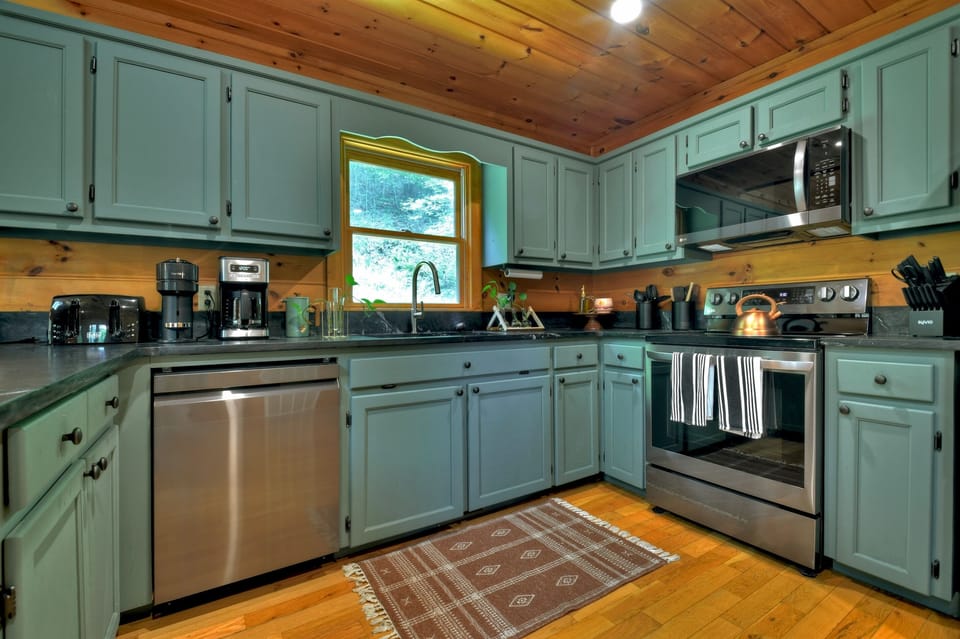 A kitchen that inspires, forest green charm, modern design, and everything you need to create.