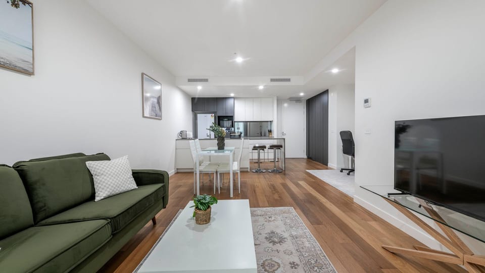 Bright lounge with comfortable seating and large flat-screen TV