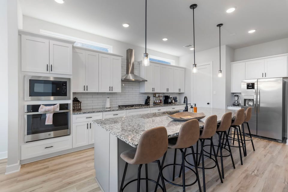 Granite counters, stainless appliances, and a 6-seat island for gathering