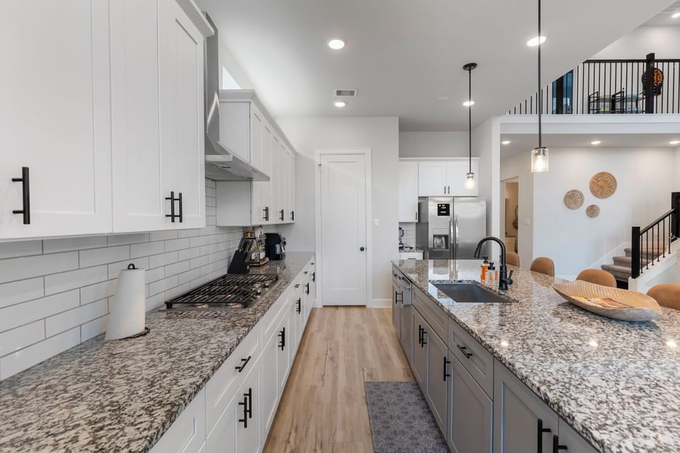 Modern chef’s kitchen with sleek granite countertops.