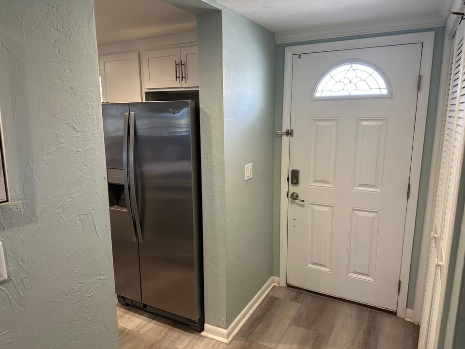 Welcoming entryway with a secure smart lock and convenient access to the fully equipped kitchen.