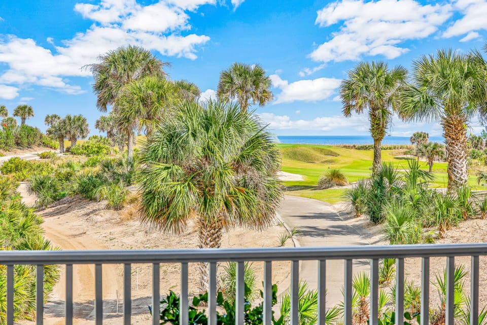 Step out onto your private balcony to enjoy stunning views of the blue ocean horizon paired with the lush greenery of a manicured golf course. This bright, tropical landscape creates the perfect coastal retreat for your next stay.