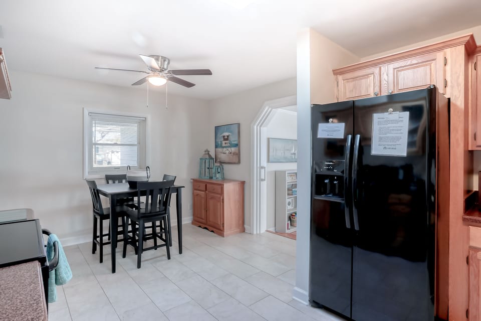 Bright kitchen and dining area with full-size appliances and a cozy table perfect for meals or morning coffee.