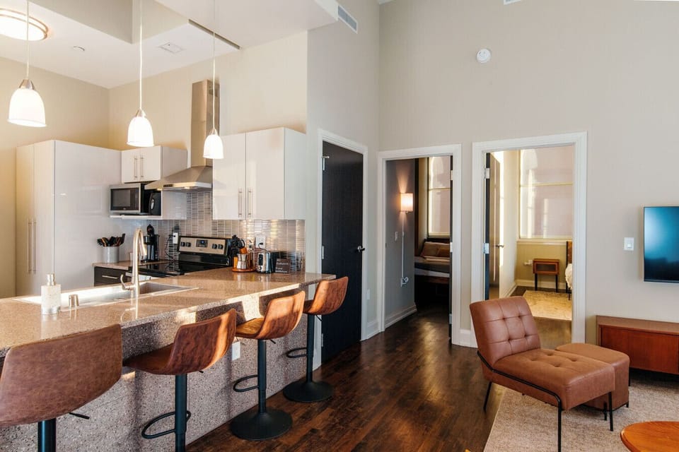 A fully-equipped kitchen featuring high-end finishes and bar seating—everything you need to prep, cook, and refuel