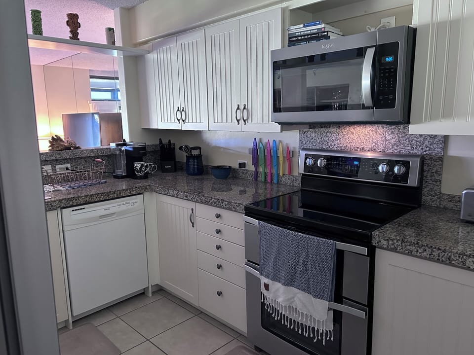 The kitchen is fully stocked  with plenty of pots, pans, glasses and dishes etc.