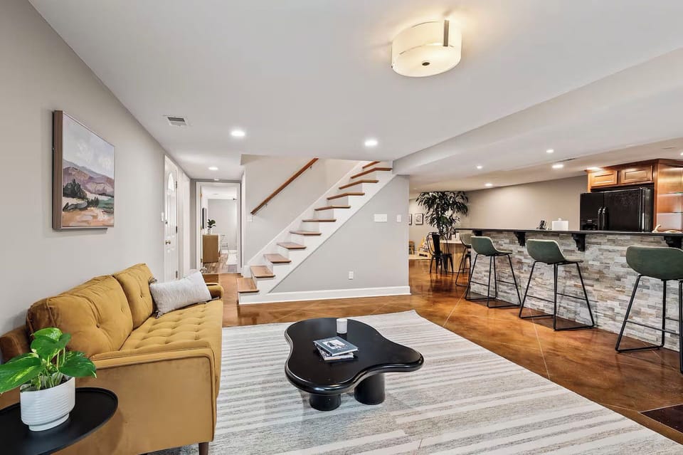 A bright and open living area featuring a cozy yellow sofa.