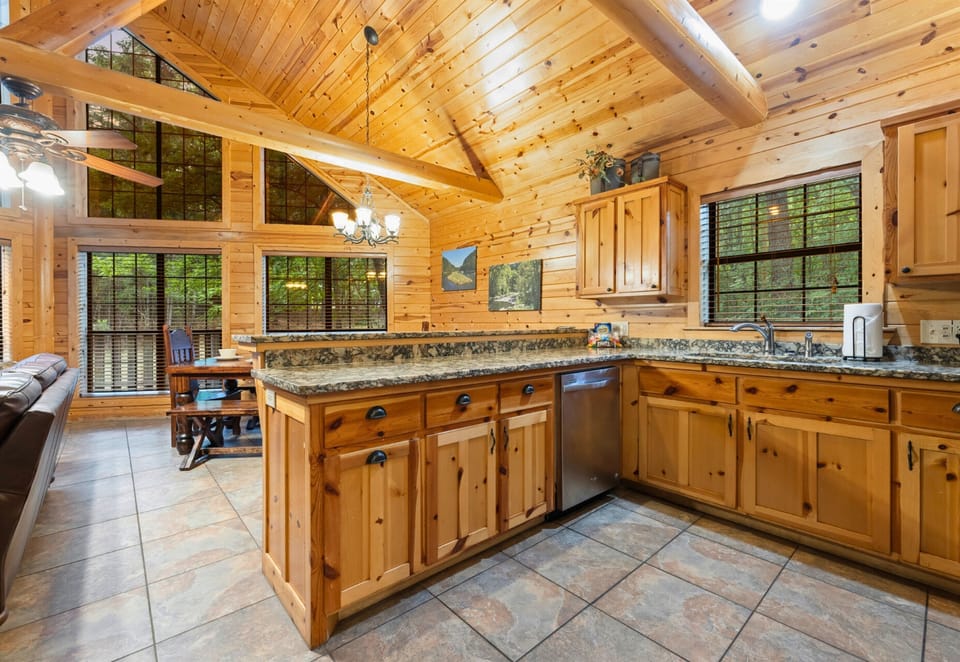Bright kitchen with forest views and cabin warmth.