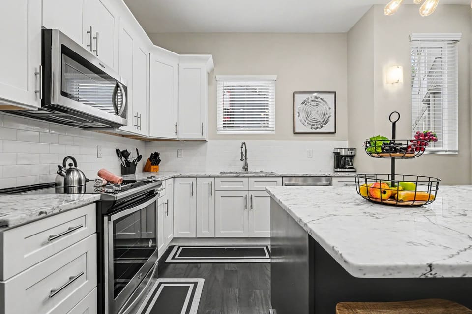 The fully equipped, modern kitchen is stocked with all the culinary essentials, including stainless-steel appliances and a wine cooler. (2nd Floor)