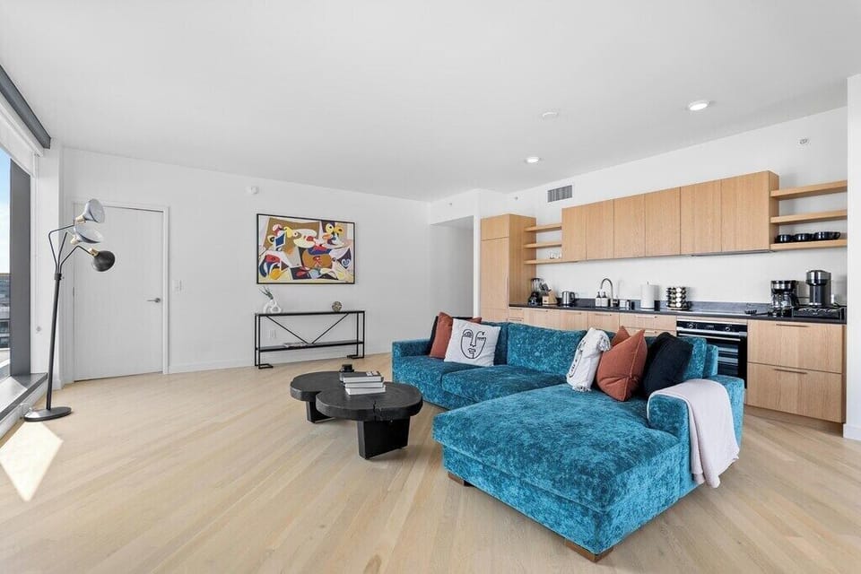 Modern space featuring an integrated kitchen and huge picture windows.