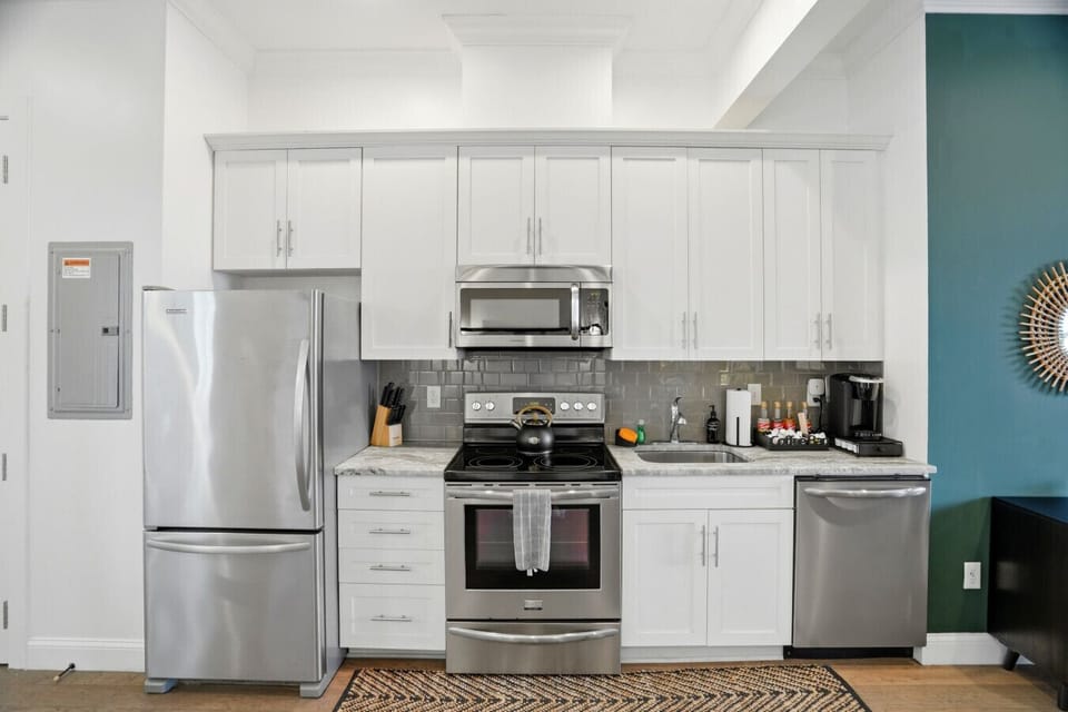 Chic, modern kitchen with Kuerig coffee machine and complimentary coffee supplies