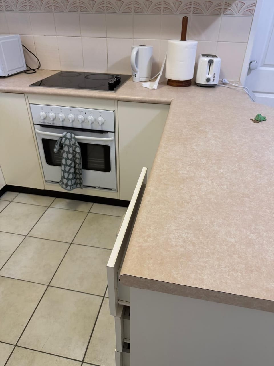 Kitchen with benchtop and two bar stools