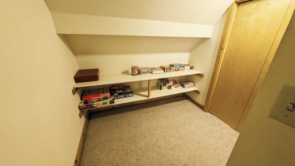 Upstairs: At the top of the stairs is a game shelf