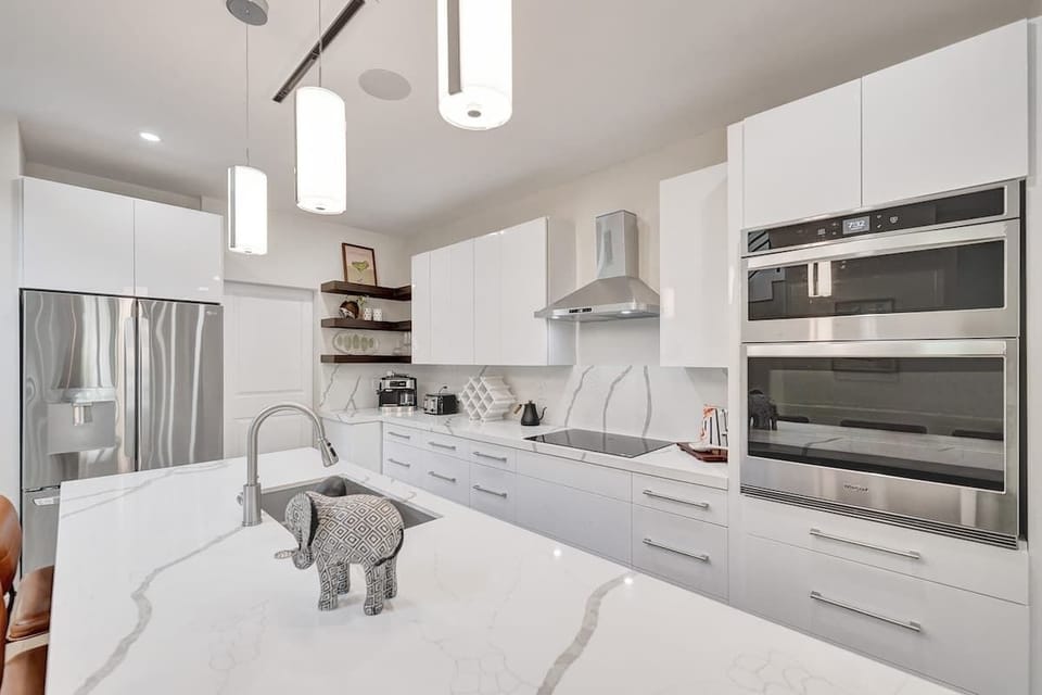Cook with ease in the sleek chef’s kitchen with premium stainless steel appliances.