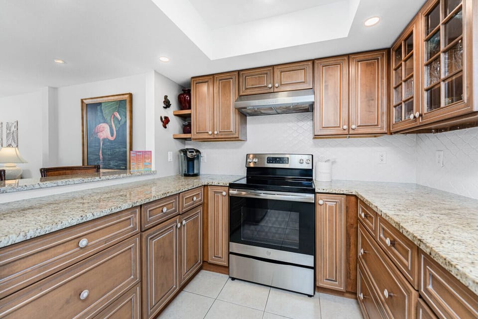 A cook’s delight - fully stocked kitchen with modern appliances,generous counter space, pantry, and an open layout to the dining and living areas.
