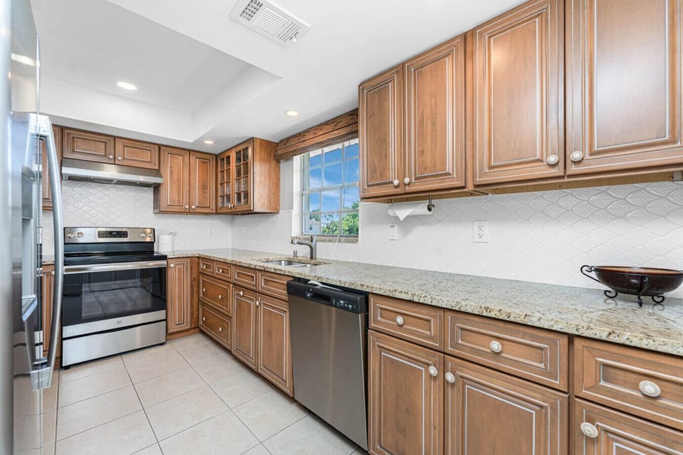 Kitchen window provides a bright and sunny overlook of the tennis court