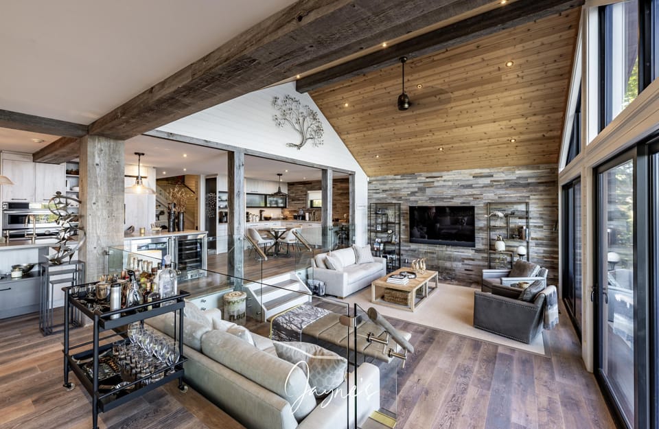 Spacious living room with vaulted ceilings and cozy stone fireplace