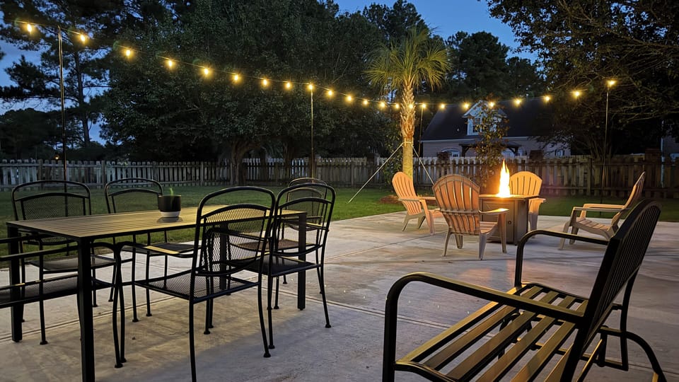 Bistro lights, Palm trees, Putting Green, Fire Pit, Dining Table, Glider