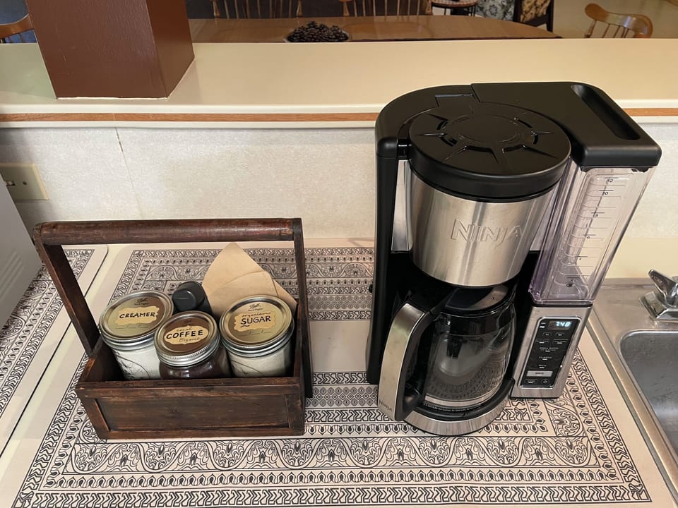 Local organic coffee, sugar, creamer & an automatic drip coffee machine for you
