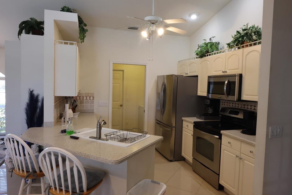 Stainless steel appliances with access to laundry