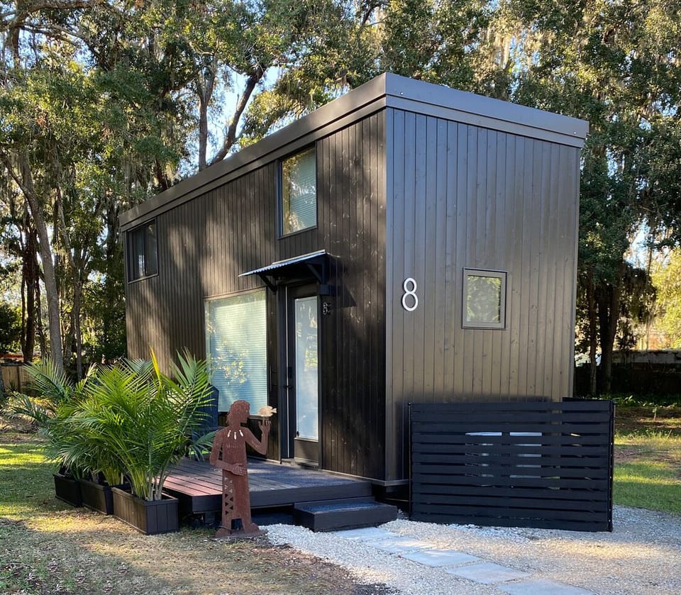 Stained wood exterior, 6' x 12' wood deck, sits on a seashell driveway 