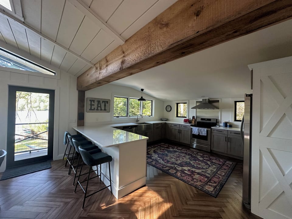 Spacious and well appointed kitchen with additional bar seating.