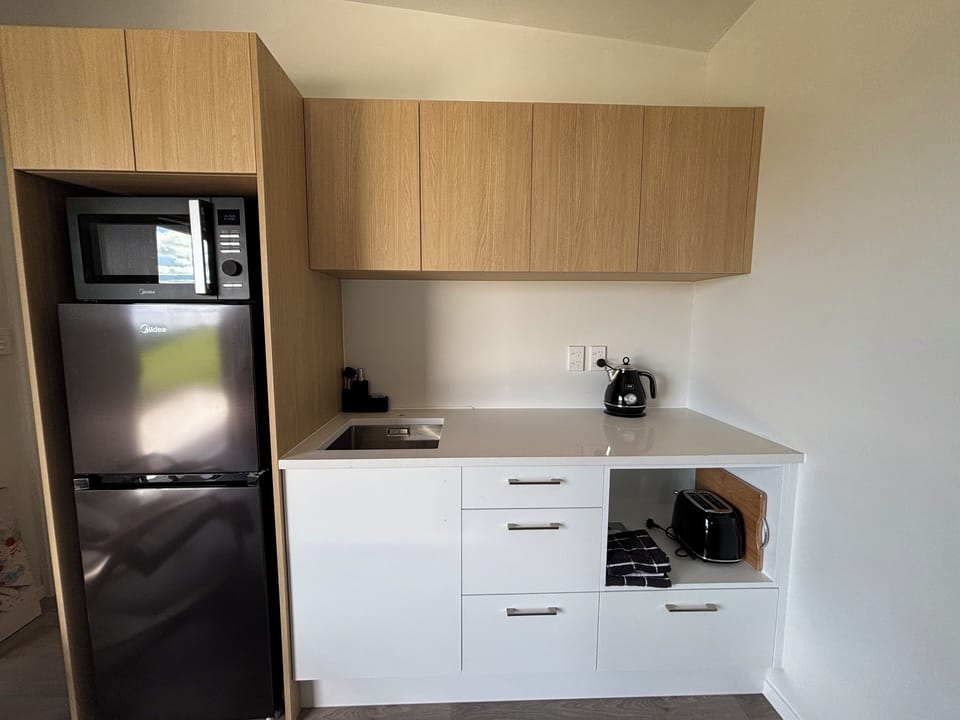 Cute kitchenette with toaster, kettle, fridge, freezer & microwave.