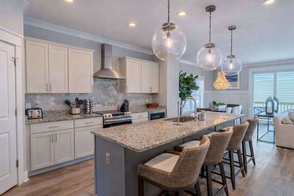 Modern, open kitchen with updated appliances and an island featuring bar seating.