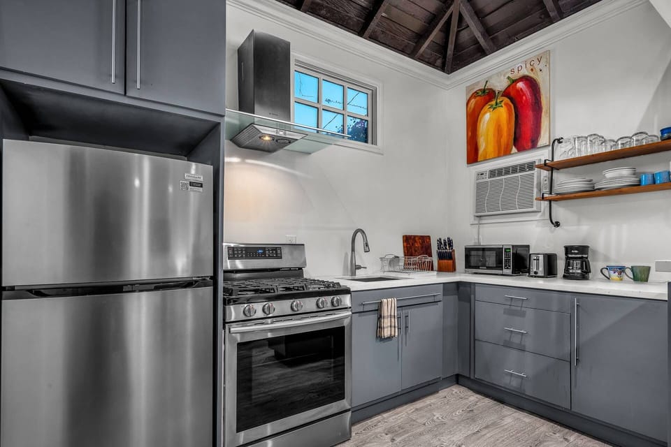 Stainless steel appliances w full size refrigerator, gas stove/oven, microwave, toaster and coffee maker