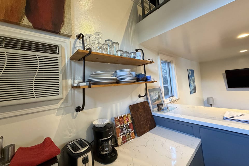 We provide full Kitchen amenities. Toaster, coffee maker, dishes, wine glasses...Plus AC w remote control.