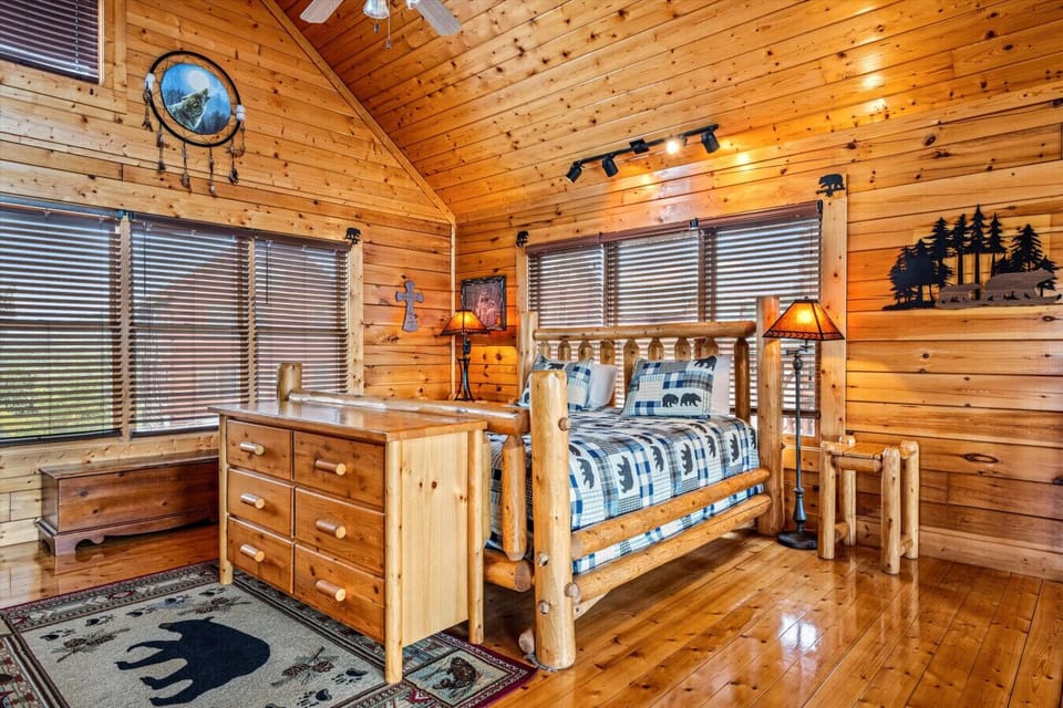 This spacious upper-level retreat features vaulted ceilings, big windows, and a bear-themed bed set—your own private lodge hideaway.