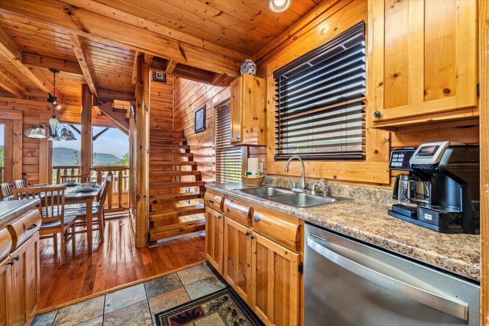 Whip up meals with ease in this well-equipped kitchen, complete with full appliances, rustic wood cabinetry, and a coffee station to start your mornings right.