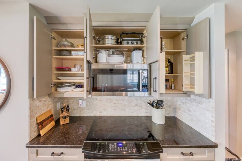 Full kitchen with a island seating for 6, drip coffee maker, blender, crockpot/slow cooker, rice cooker, ground coffee, sugar, tea, and basic condiments (ketchup, mustard, relish.)