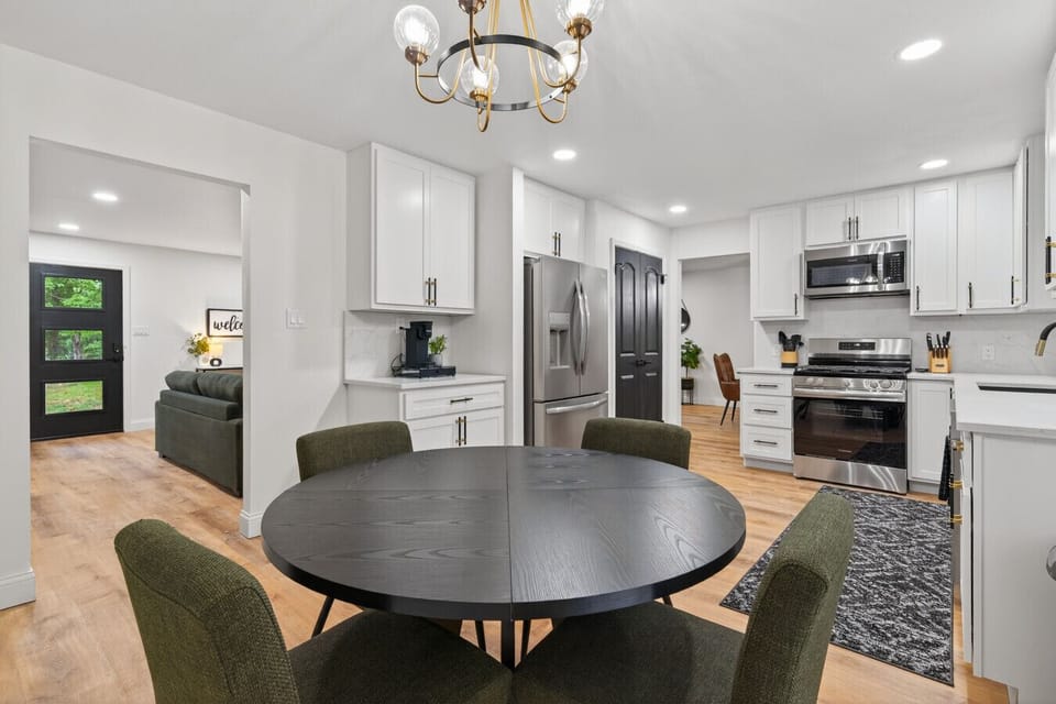 Discover a remodeled dining room connected to the kitchen, leading out to a new expansive deck and lounge area. Perfect for family meals, entertaining, and gatherings, it blends modern style, space, and indoor-outdoor flow for ultimate comfort and fun.