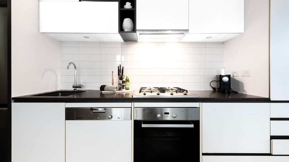 Sleek kitchen with oven, stove, and contemporary finishes