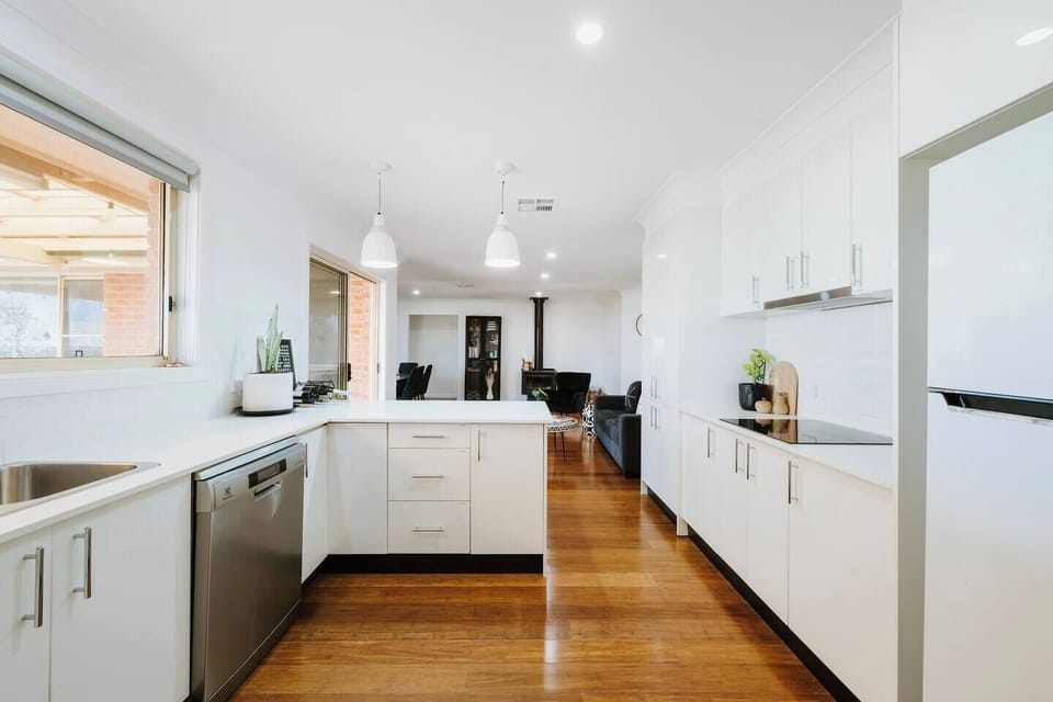 Prepare meals in the fully equipped kitchen, complete with a dishwasher, electric cooktop, oven, microwave, fridge, and all the cooking basics you’ll need.