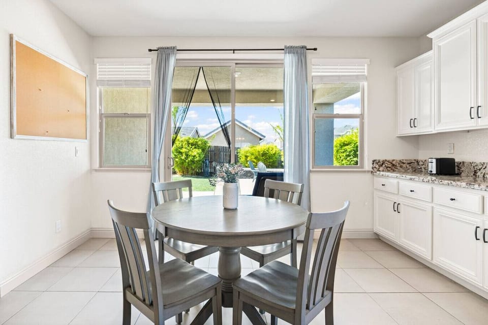 Enjoy breakfast with a view of the backyard through bright windows and sliding doors.
