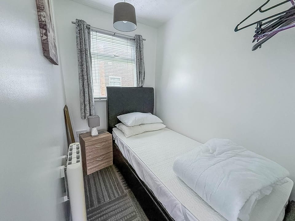 Practical single chalet bedroom, designed to offer comfort and functionality for your UK travels!
