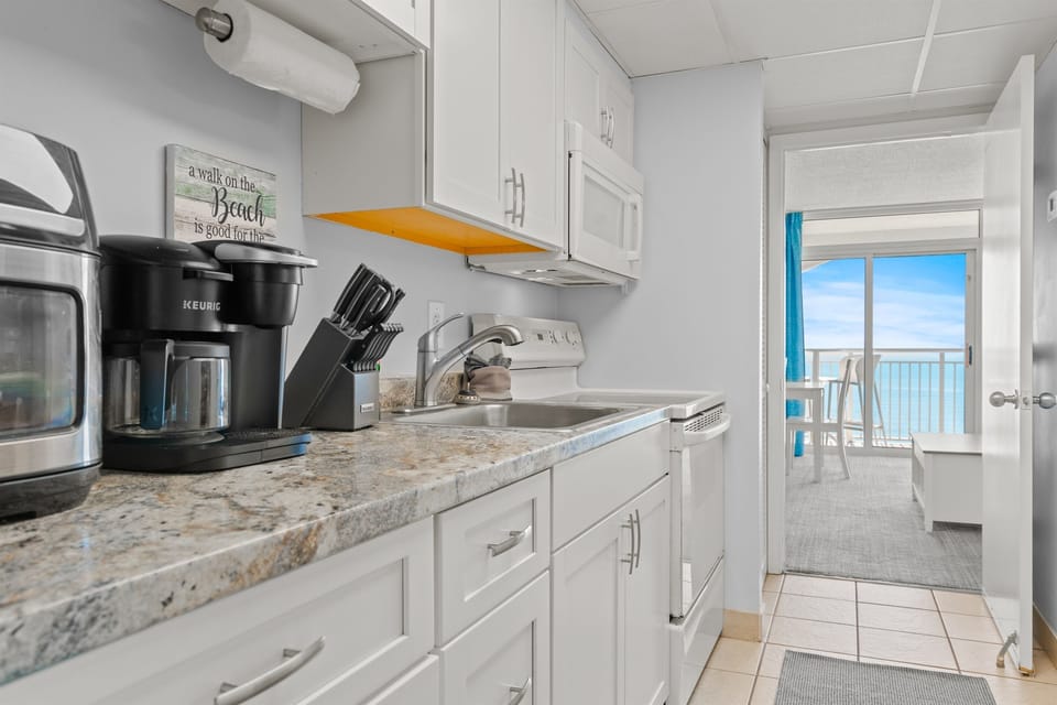 Full size fridge, range oven, microwave, coffee maker, dishes, utensils, basic pots and pans.