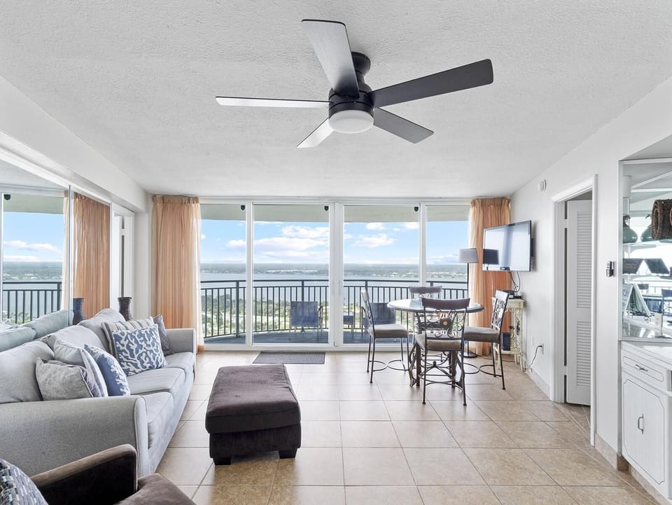 Sunlit living room with panoramic ocean views and cozy seating