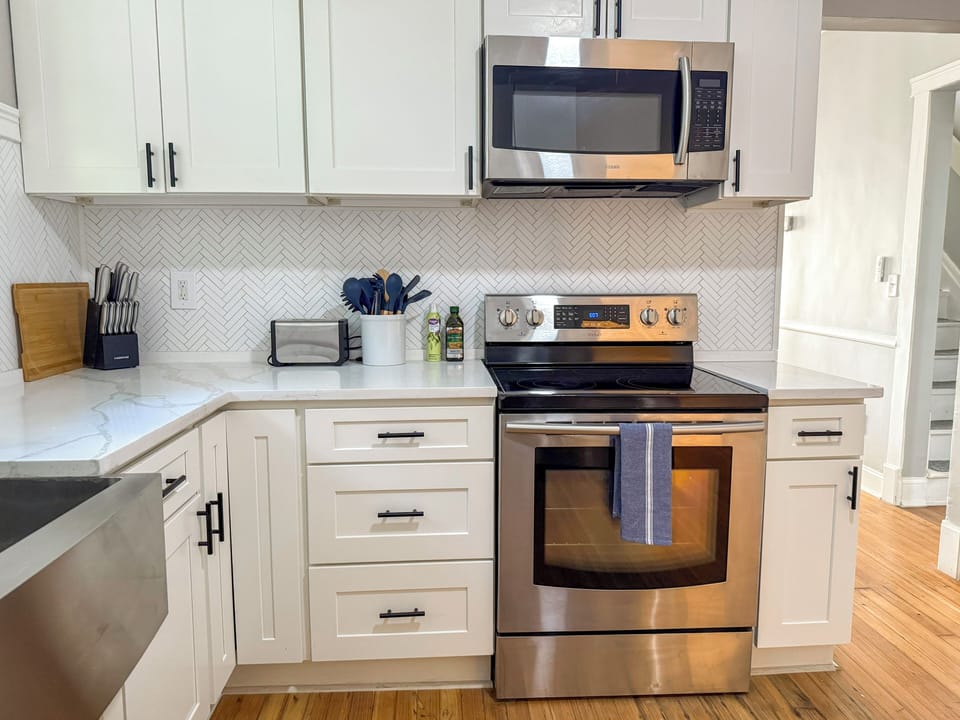 Kitchen stocked with knives, spices, cookware, and all dining essentials.