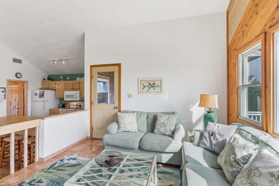 Gather together in the bright, open living space with cozy furnishings, a flat-screen TV, and easy access to the furnished sun deck.