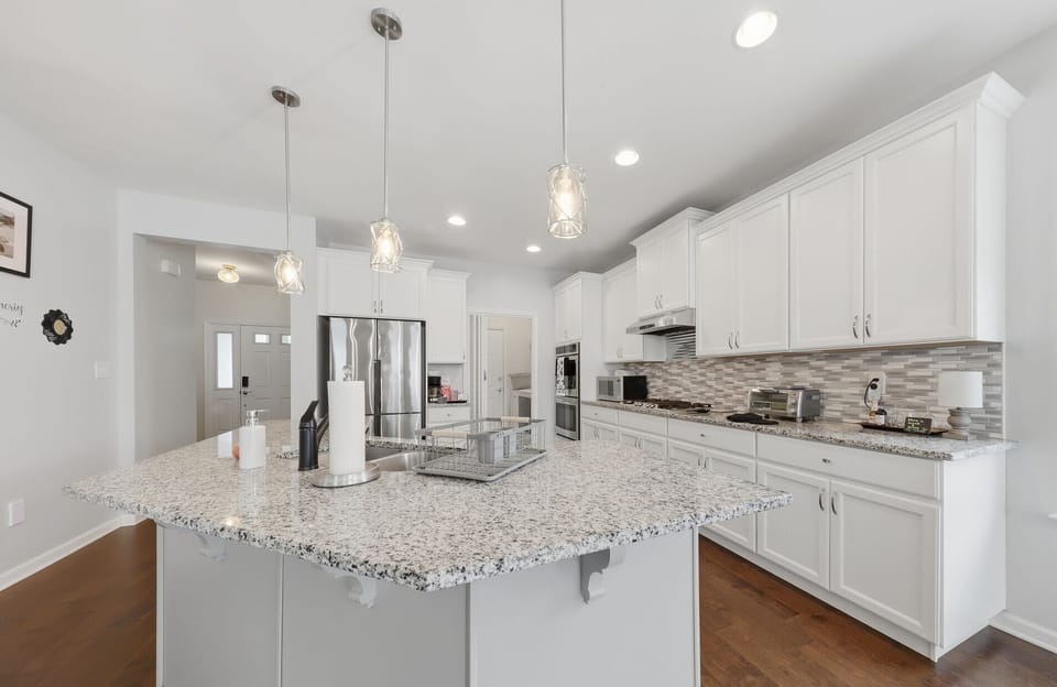 Stainless steel appliances, granite countertops and real wood cabinets