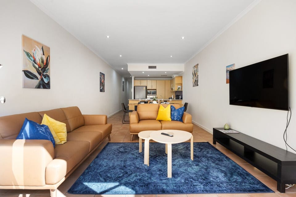 Soak up the natural light in this open-plan living area—perfect for curling up with a good book, enjoying a chat, or catching up on your favourite series.