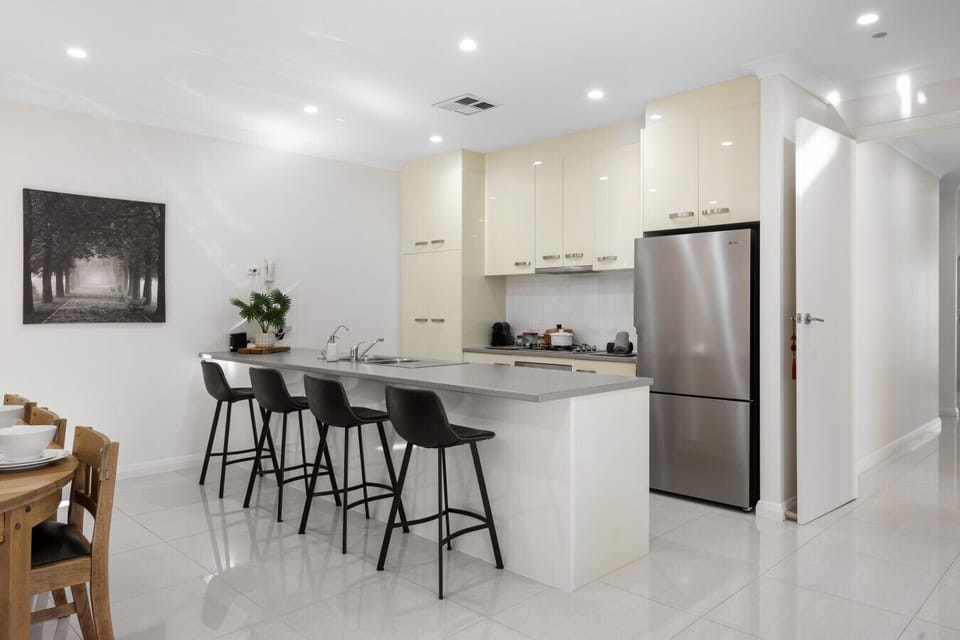 Whip up something delicious in the modern kitchen featuring sleek finishes and a breakfast bar for casual bites