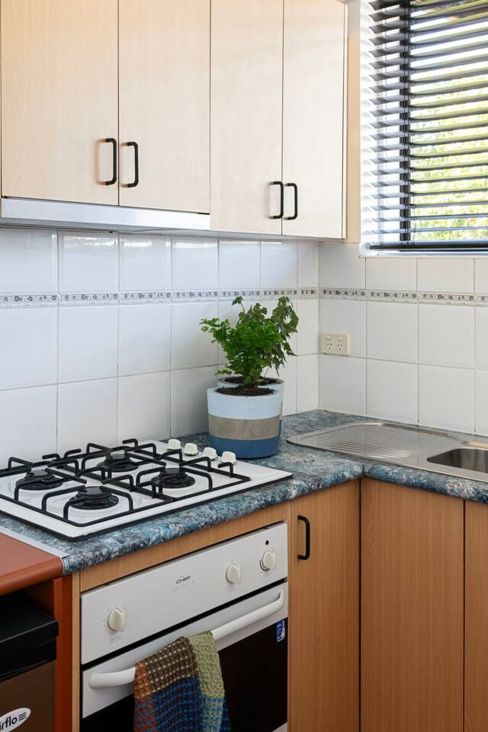 Whip up your favorite home-cooked meals with ease using this fully equipped gas stovetop and kitchen setup.