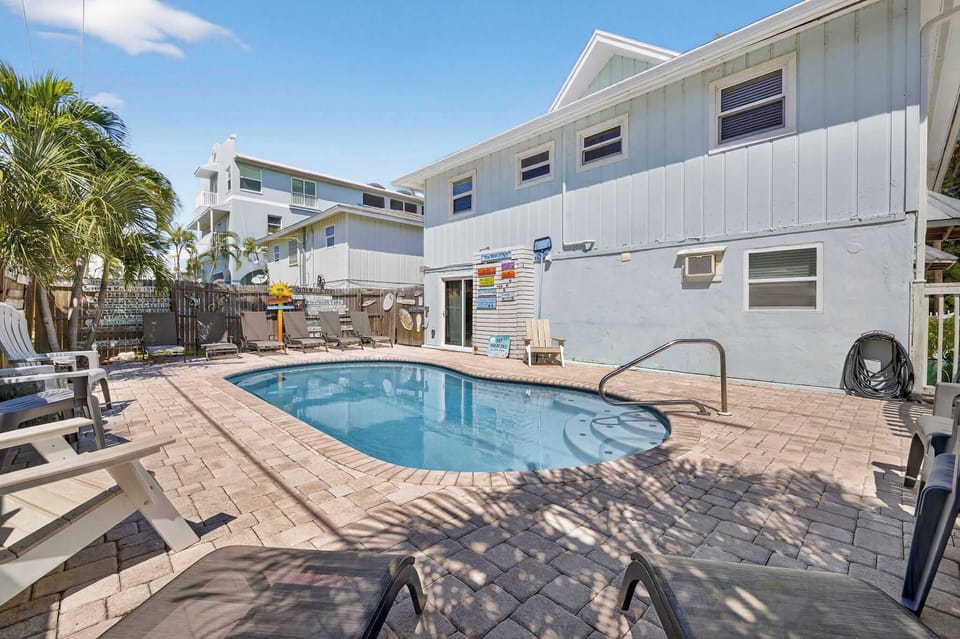 Beautiful heated pool with ample loungers and chairs
