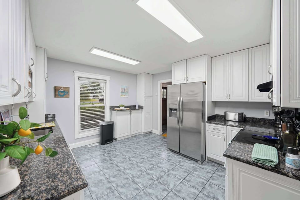 The large kitchen includes everything you need to cook up a feast, including a bar setup with cocktail tools and glassware.