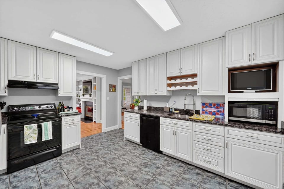 The large kitchen includes everything you need to cook up a feast, including a bar setup with cocktail tools and glassware.