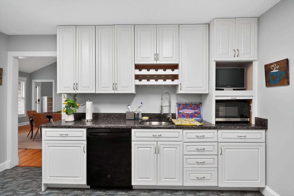 The large kitchen includes everything you need to cook up a feast, including a bar setup with cocktail tools and glassware.
