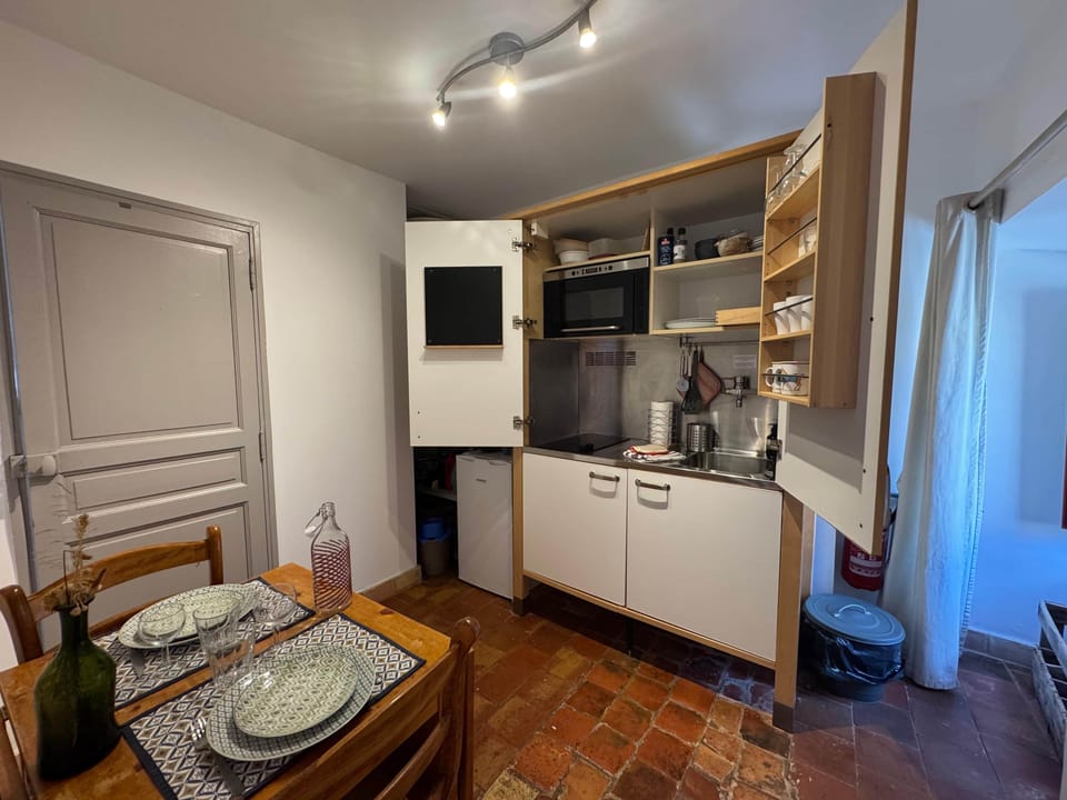 kitchen, microwave, dining table, chairs